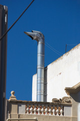 Fototapeta na wymiar Chimney for heating in a house in the center of the city