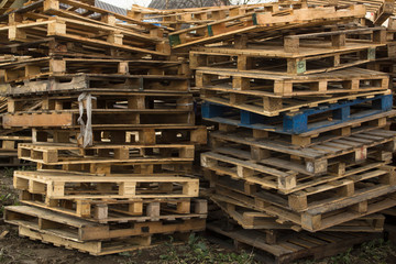 Huge stack of different type of pallet at a recycling business area