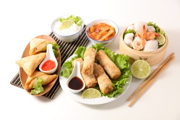 selection of asian meal with spring roll, samossa, fried noodles, soup