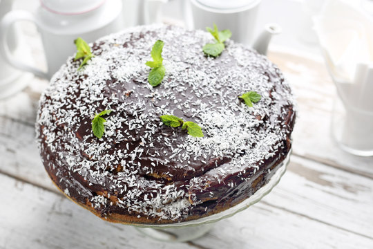 Chocolate cake with a chocolate coating and coconut chop decoration.