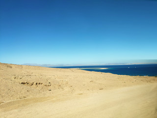 Fototapeta na wymiar Desert land with mountains and sea