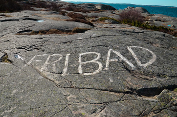 Word written on a mountain in the Swedish archipelago, Translation: Skinny dipping