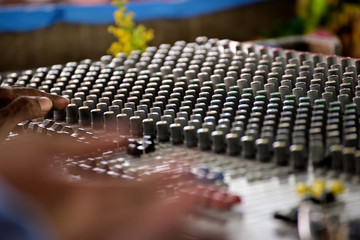 Close-up of sound mixer in a studio mixing sound.