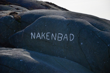 Word written on a mountain in the Swedish archipelago, Translation: Skinny dipping