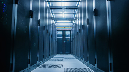 Data Center With Between Two Rows of Fully Operational Server Racks. Modern Telecommunications, Cloud Computing, Artificial Intelligence, Database, Supercomputer Technology Concept.