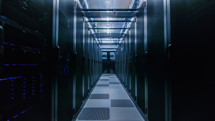 Data Center With Between Two Rows of Fully Operational Server Racks. Modern Telecommunications, Cloud Computing, Artificial Intelligence, Database, Supercomputer Technology Concept.