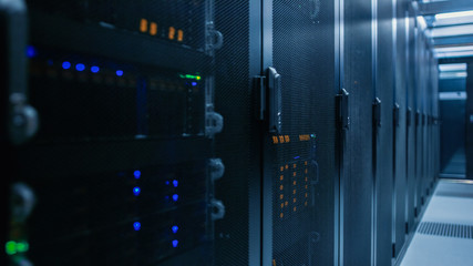 Close-up Shot of Data Center With Rows of Fully Operational Server Racks. Concept of Telecommunications, Cloud Computing, Artificial Intelligence, Database, Supercomputer Technology. 