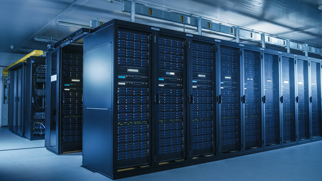 Shot of Modern Data Center With Multiple Rows of Operational Server Racks. Modern High-Tech Database Super Computer Clean Room.
