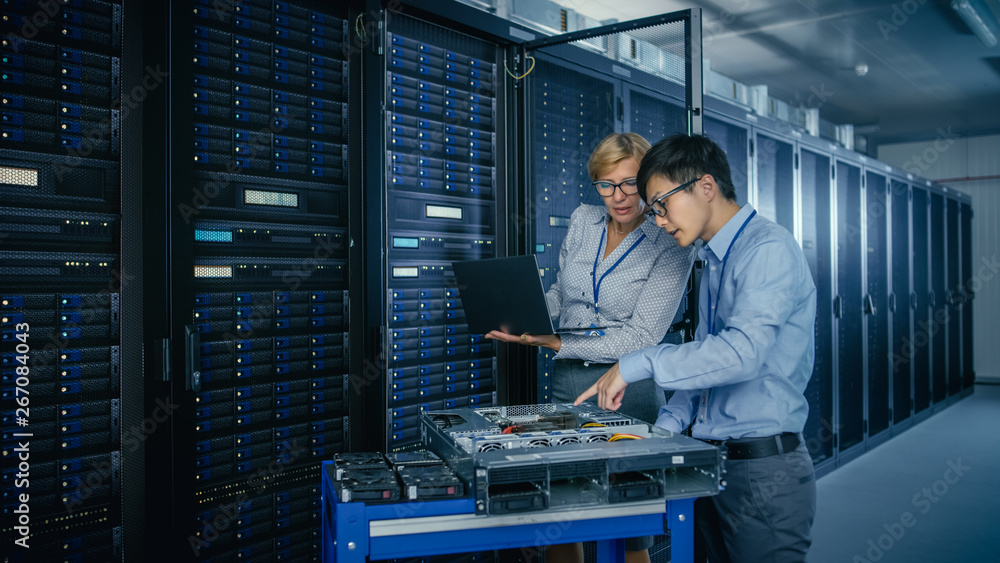 Aufkleber In the Modern Data Center: Engineer and IT Specialist Work with Server Racks, on a Pushcart Equipment for Installing New Hardware. Specialists Doing Maintenance and Diagnostics of the Database.