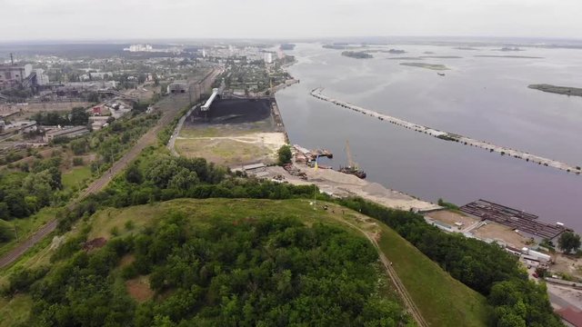 Aerial view. Ukrainian flag on the hill near big water reservoir.