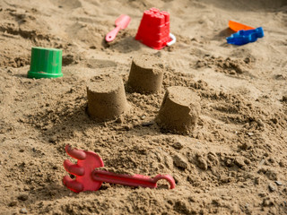 Fototapeta na wymiar Children sandbox with plastic toys side view