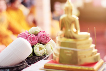 Beautiful pink lily and lotus flowers decoration on Engagement bowl for pray Buddha statue.Thai wedding culture tradition.