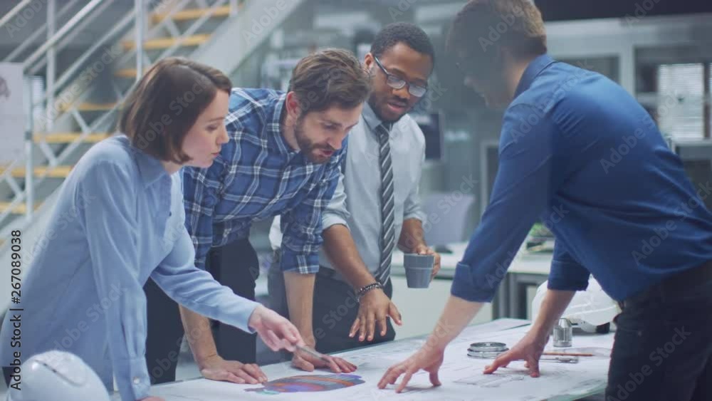Poster In the Industrial Engineering Facility: Diverse Group of Engineers, Technicians, and Specialists on a Meeting, Have Discussion, Analyze Engine Design Technical Drafts that are Lying on the Table