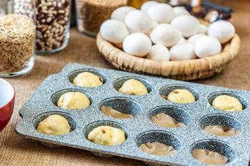 Filling a cake baking pan with dough