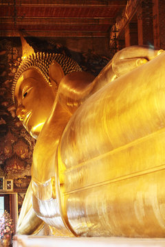 Big golden reclining Buddha image at Wat Pho temple, Thailand.