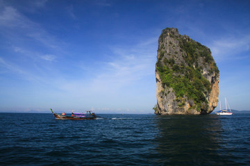 Isolated limestone rock in blue Andaman Sea near Ao Nang, Krabi, Thailand
