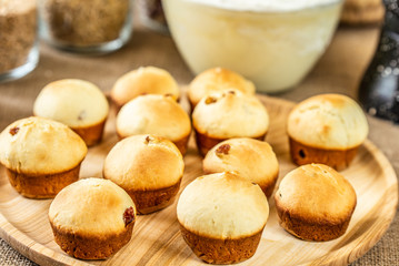 Baked muffins on a wooden plate