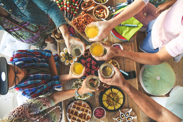 Toast with friend dinner on the terrace enjoying together. Summer aperitif with group of friends....