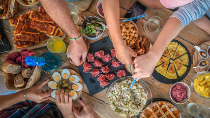 Evening with friend dinner on the terrace enjoying together. Summer aperitif with group of friends...