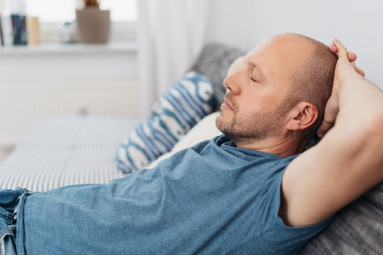 Middle-aged man relaxing with closed eyes