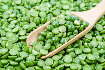 Green dry peas with wooden spoon.