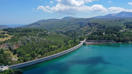 Aerial drone photo of famous lake and dam of Marathon or Marathonas with beautiful clouds and blue sky, North Attica, Greece