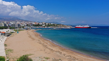 Aerial drone bird's eye panoramic view of famous port and city of Rafina with passenger ferries travel to Aegean islands, Attica, Greece