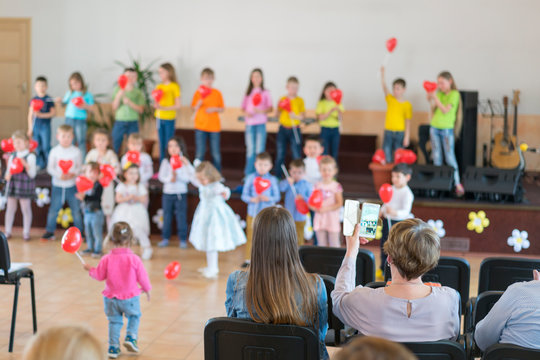 Performance by talented children. Children on stage perform in front of parents. image of blur kid 's show on stage at school , for background usage. Blurry