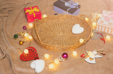 Christmas lights and garland in wooden basket. Winter season and New Year background. Celebration holidays. Presents, gifts, greeting postcard for Valentine's day. Copy space.