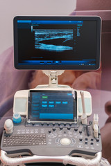 Interior of hospital room with ultrasound machine. Interior of examination room with ultrasonography machine in hospital. vertical photo
