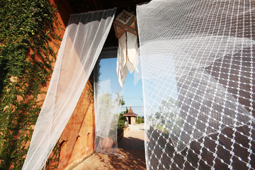 White silk curtains in the wind decoration in the tropical lanna garden of Thailand