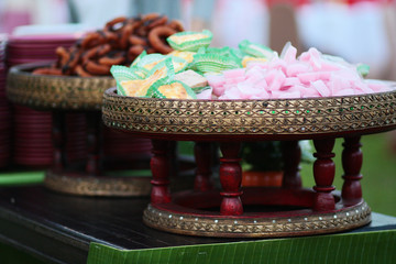 Thai Sweet desserts pink jelly in heart shaped and banana cupcake on rattan basket in wedding garden