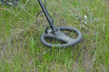 metal detector at work searching in the grass