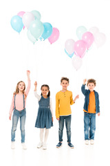 Obraz premium full length view of four kids holding balloons isolated on white