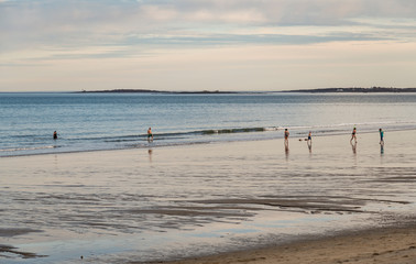 Fototapeta na wymiar People walk on the beach in Maine, USA