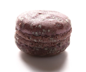 side view purple moldy macaroon on a white background