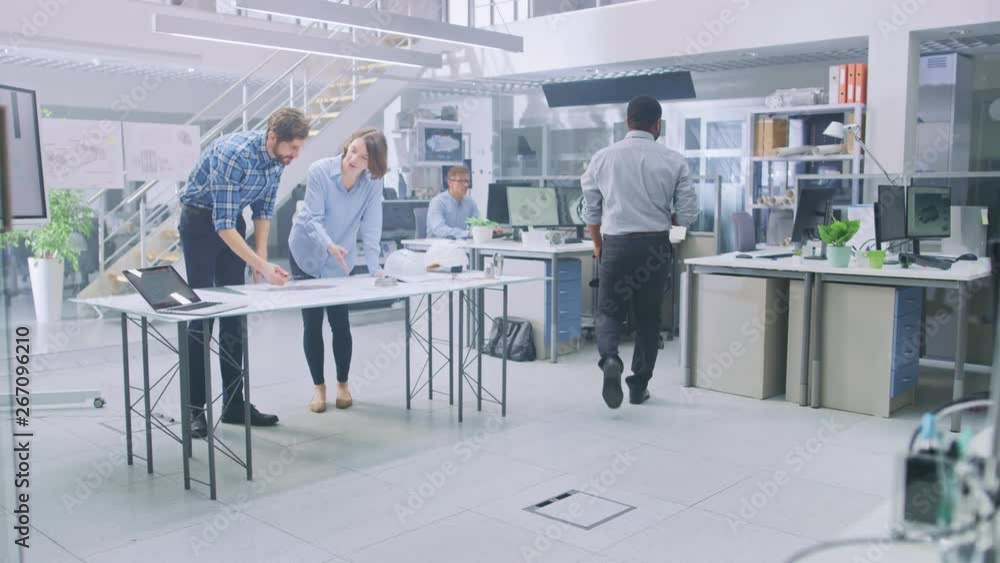 Poster in the busy engineering facility: diverse group of engineers, technicians, working on design for ind