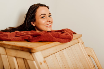smiling woman taking steam bath in spa center