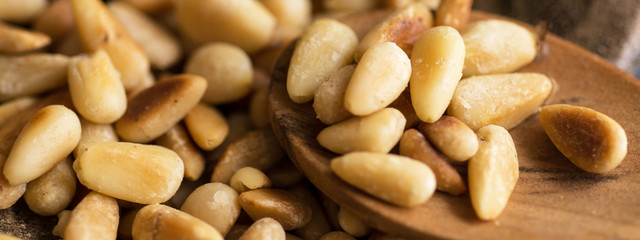Pine Nuts on Dark Wooden Table. Toasted Organic Healthy Food.