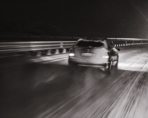 car on the highway in snowy night