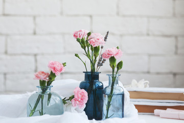 Obraz na płótnie Canvas beautiful glass vases, wicker bag on a shelf near the wall