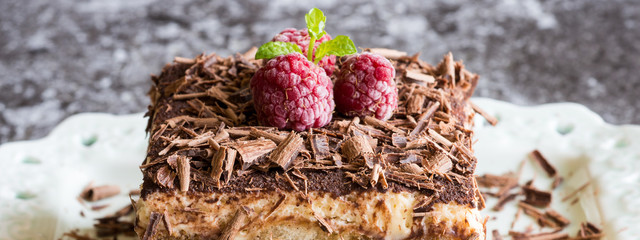 Homemade Tiramisu Cake Dessert with Grated Chocolate, Raspberry and Mint