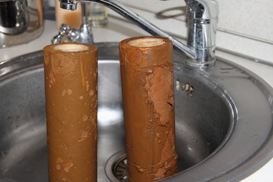 Brown old dirty water filters with rust - water pipe, drinking water purification and cleansing