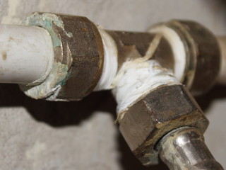 Rustic pipe tap with fitting close up - old plumbing repair