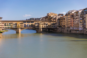 Sunny view on the Arno River and Ponte Vecchio in Florence, Italy