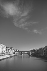 Sunny view on the Arno River and Ponte Vecchio in Florence, Italy