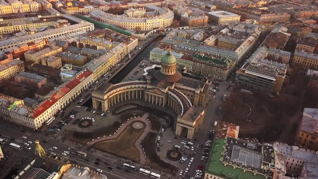 Aerial spring sunset view of Saint Petersburg Nevsky prospect Kazan cathedral Kazanskiy Kafedralniy Sobor Singer House of the Book tower Griboyedov Canal church roofs road cars rooftops famous place o
