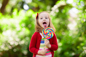 Little girl with colorful candy lollipop