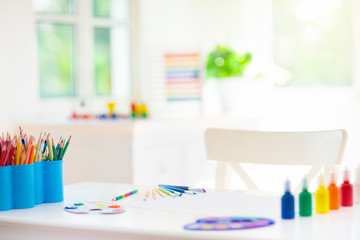 Kids bedroom with wooden, paint and art supplies.