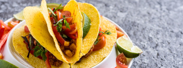 Tacos in Shells with Vegetables on Stone Background